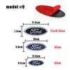A set of three Ford emblem badges in dark blue, blue, and a lighter blue color.