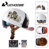 A white motorcycle helmet with gold Boss logo and a brown strap, shown alongside accessories.
