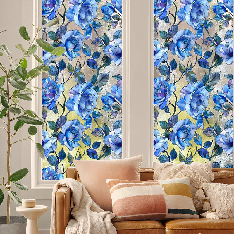 A close-up of a window featuring decorative blue and green floral stained glass patterns.