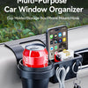 A black multi-purpose car window organizer holding a red can and a smartphone mount in a car door.
