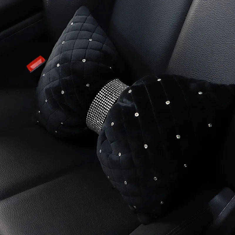 A set of black velvet car neck pillows adorned with silver diamond rhinestones.