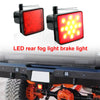 A close-up of a red LED rear fog light brake light mounted on a trailer hitch.