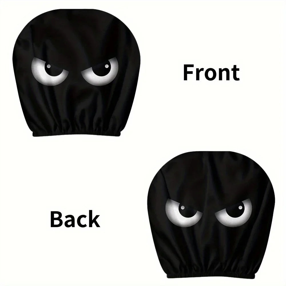 A set of two black car headrest covers with slanted eyes designs shown from the front and back.