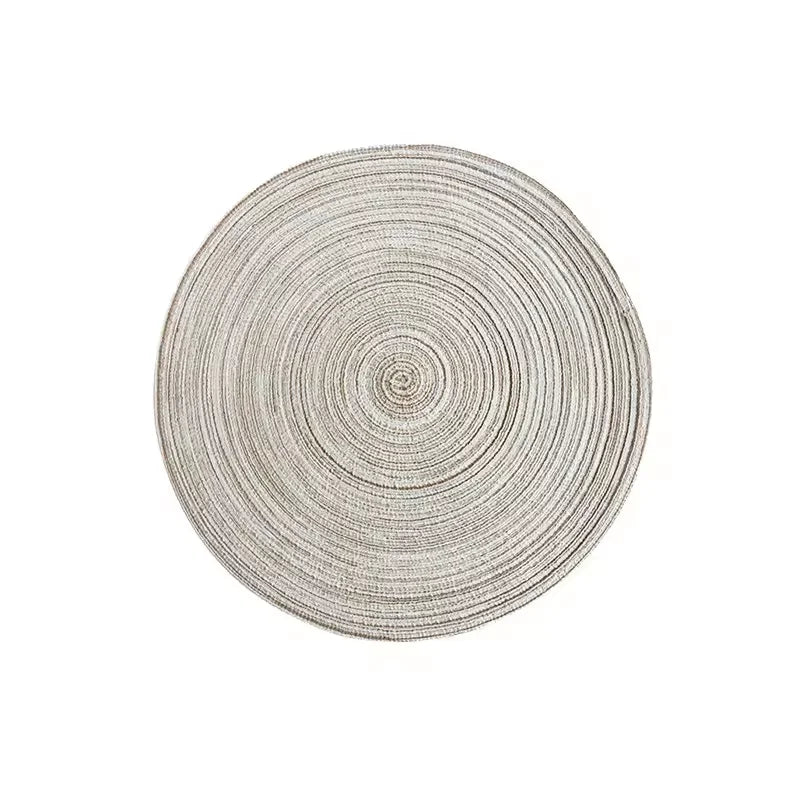 Round placemat made of gray cotton yarn with concentric circular texture