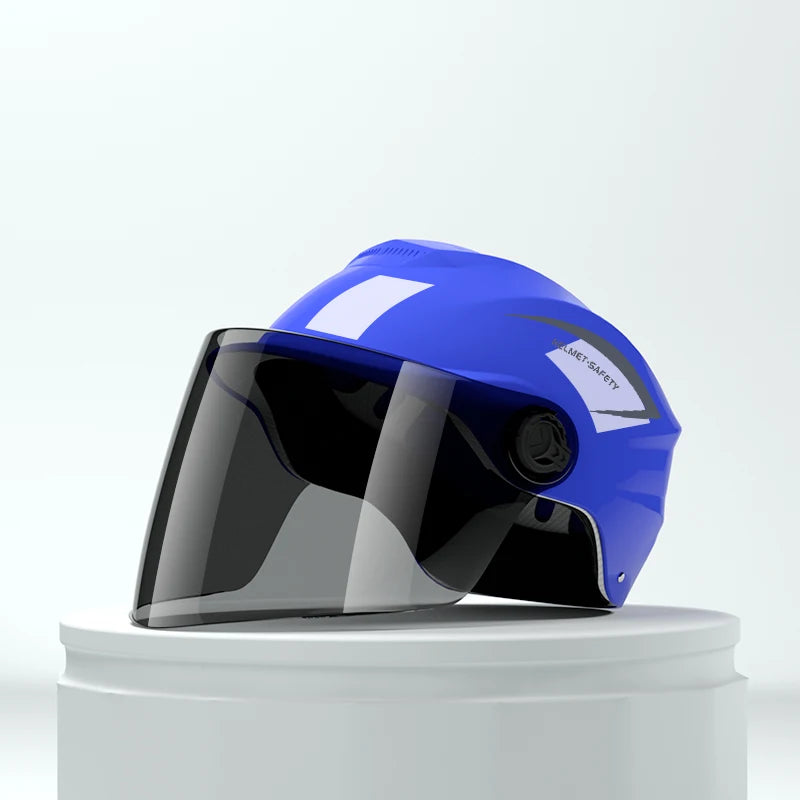 A bright blue lightweight rainproof half helmet with a clear visor is displayed on a white stand.