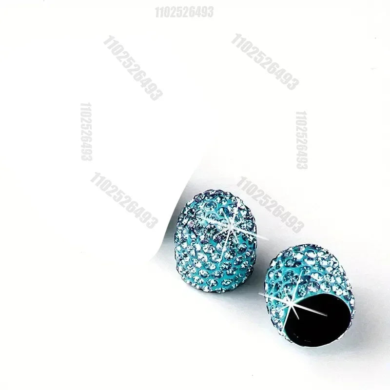 A set of crystal diamond finish tire valve caps with blue and clear stones.