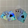 A fan of poker theme motorcycle decals showing several iridescent playing cards laid out on a grid background.