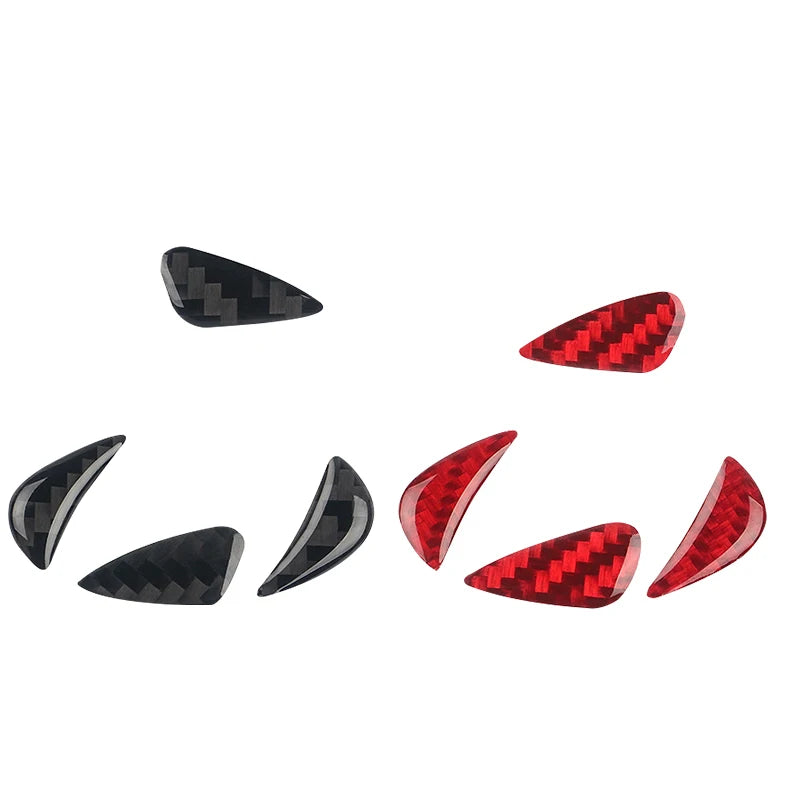 Set of four carbon fiber steering wheel trim decals in black and red patterns
