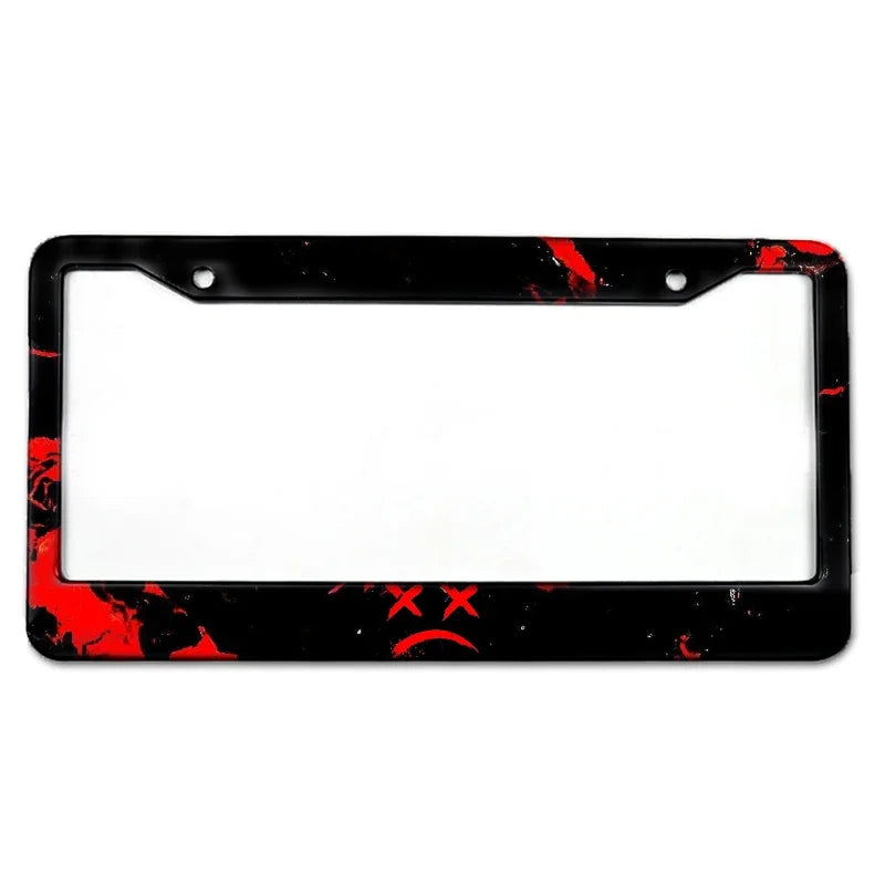 Black license plate frame with red splatter design and a clear rectangular opening.