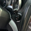 Close-up view of a black cylindrical car start stop button accessory mounted on a vehicle dashboard.