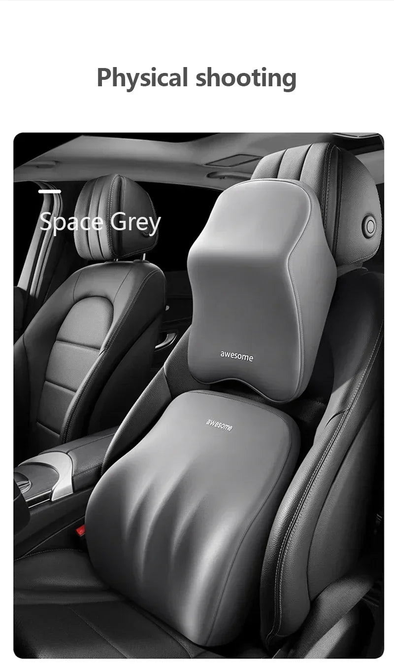 Close-up view of a grey ergonomic lumbar and neck support cushion installed in a car seat.