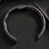 A black breathable perforated leather steering wheel cover is shown against a dark background.