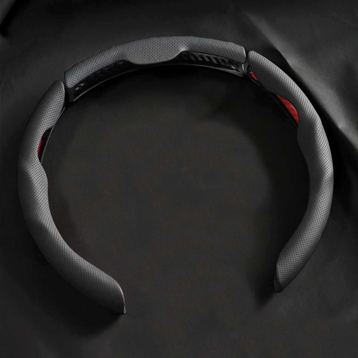 A black breathable perforated leather steering wheel cover is shown against a dark background.
