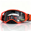 Orange safety goggles with a lens lock feature shown on a reflective surface.