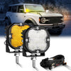 A powerful LED off-road driving light mounted on a bar, shown next to a white SUV.
