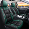 Two green and black leather car seat covers installed in a vehicle interior.