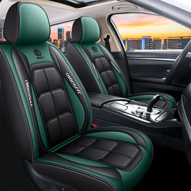 Two green and black leather car seat covers installed in a vehicle interior.