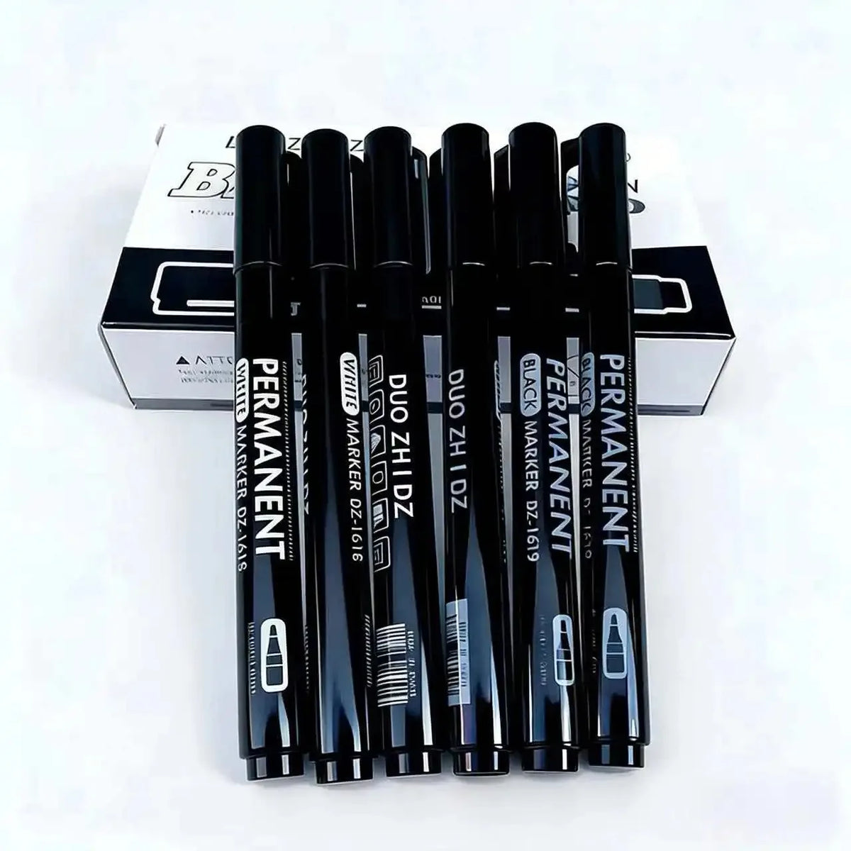 A set of black and white permanent paint markers for art, craft, and DIY displayed in their packaging.