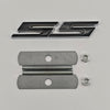 A silver and black 3D metal SS/RS emblem badge for Chevrolet vehicles, shown with mounting hardware.