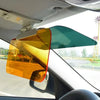 A dual-function anti-glare car sun visor with a split design in orange and teal colors mounted on a vehicle window.