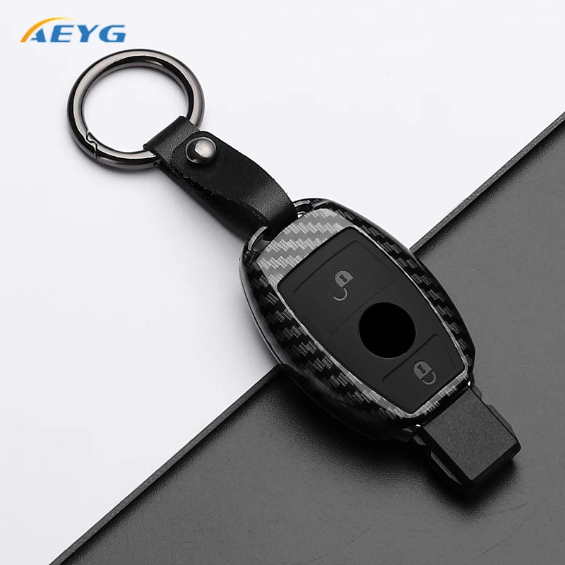Black carbon fiber car key cover with a metal ring and electronic components