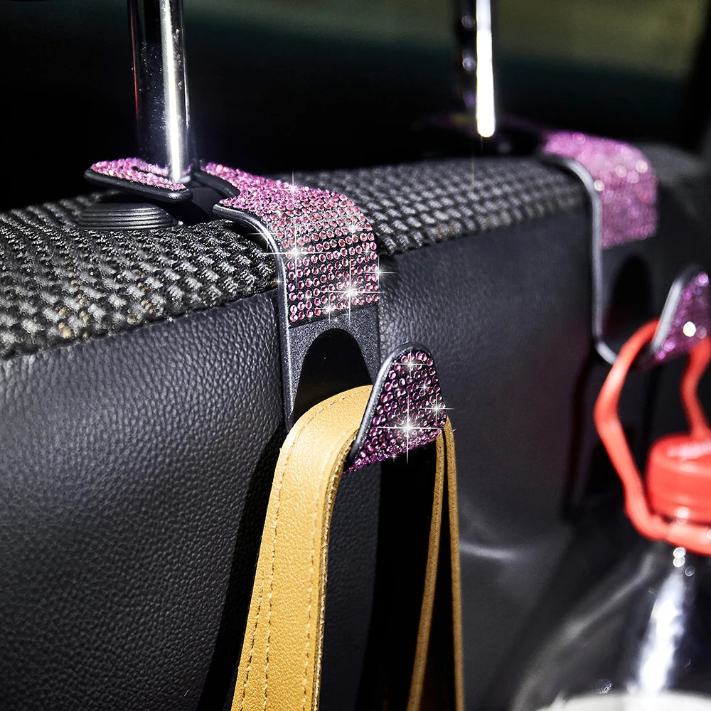 Close-up of black storage hooks with purple glitter accents and a tan leather strap.