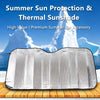 Silver reflective sun shade or visor placed on a wooden surface with icy mountain background.