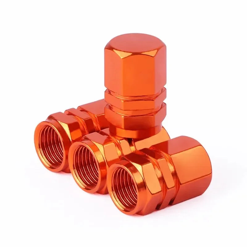 A set of bright orange aluminum alloy tire valve caps for auto and motorcycle tires.