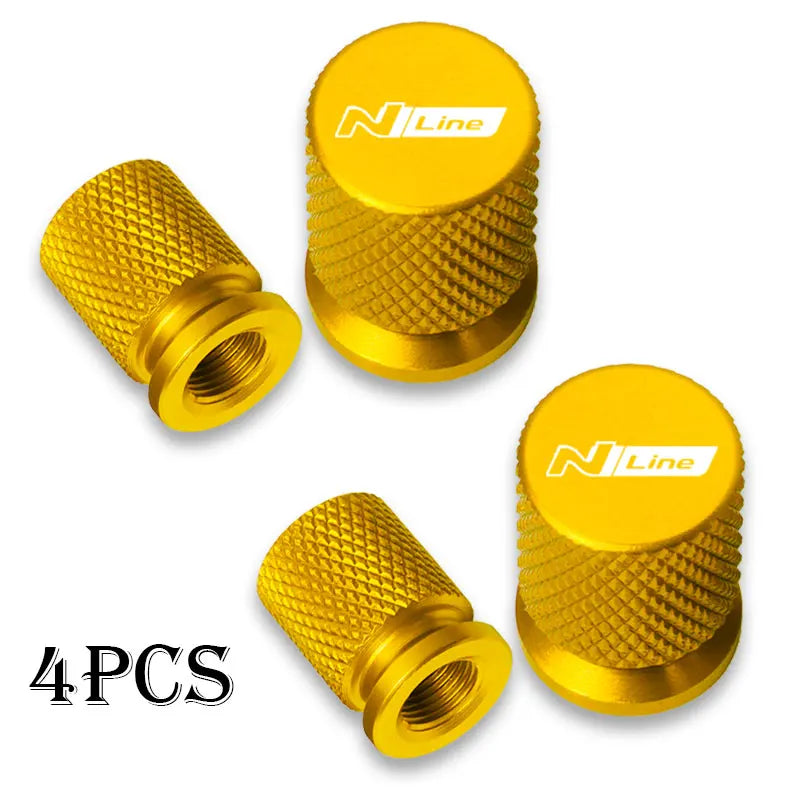Set of four gold-colored aluminum tire valve caps with N Line branding