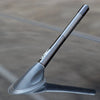 A black carbon fiber radio antenna is shown mounted on a vehicle surface.