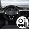 A close-up view of a car interior showing a steering wheel, dashboard controls, and various accessory pads.