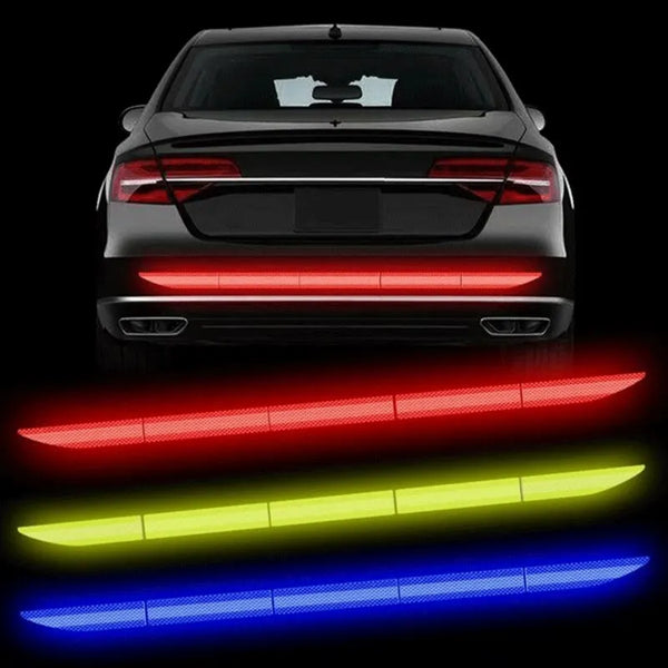 Rear view of a black car with illuminated red, green, and blue safety lights.