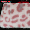 Pink leopard print plush fabric used as an armrest pad cover