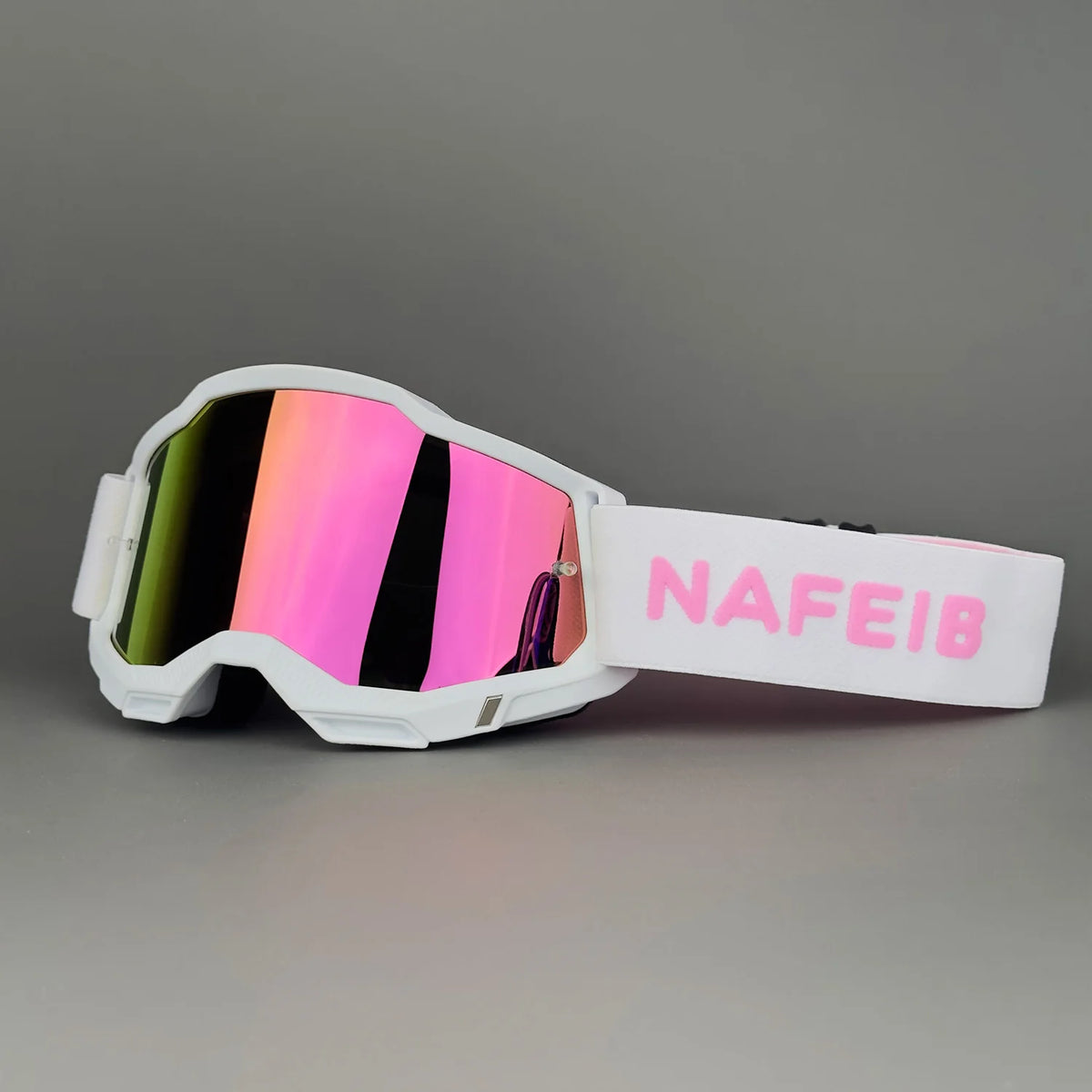 White off-road racing goggles with a pink strap and iridescent lenses