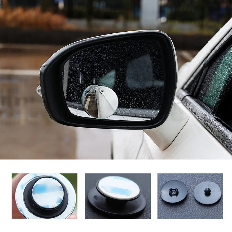 Close-up view of a black side view mirror with a rotating blind spot camera mounted on the housing.