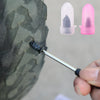 A hand uses a tool to insert a rubber plug into a tire, next to two reusable plastic plugs.
