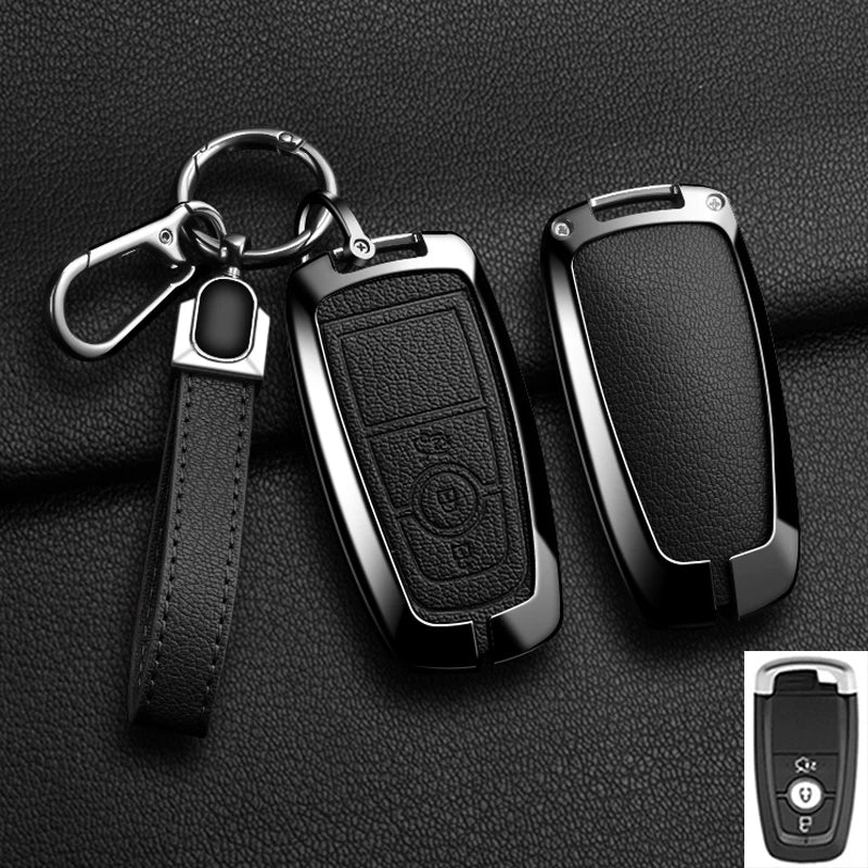 A black aluminum alloy key fob cover with a chain and strap is shown against a dark background.