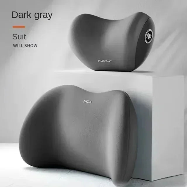A dark gray ergonomic memory foam neck and lumbar pillow set shown in a studio setting.