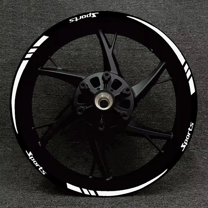 A black sports motorcycle wheel with white reflective decals and spokes.