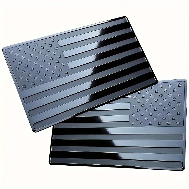 Matte black 3D American flag decals featuring stars and stripes on a rectangular surface.