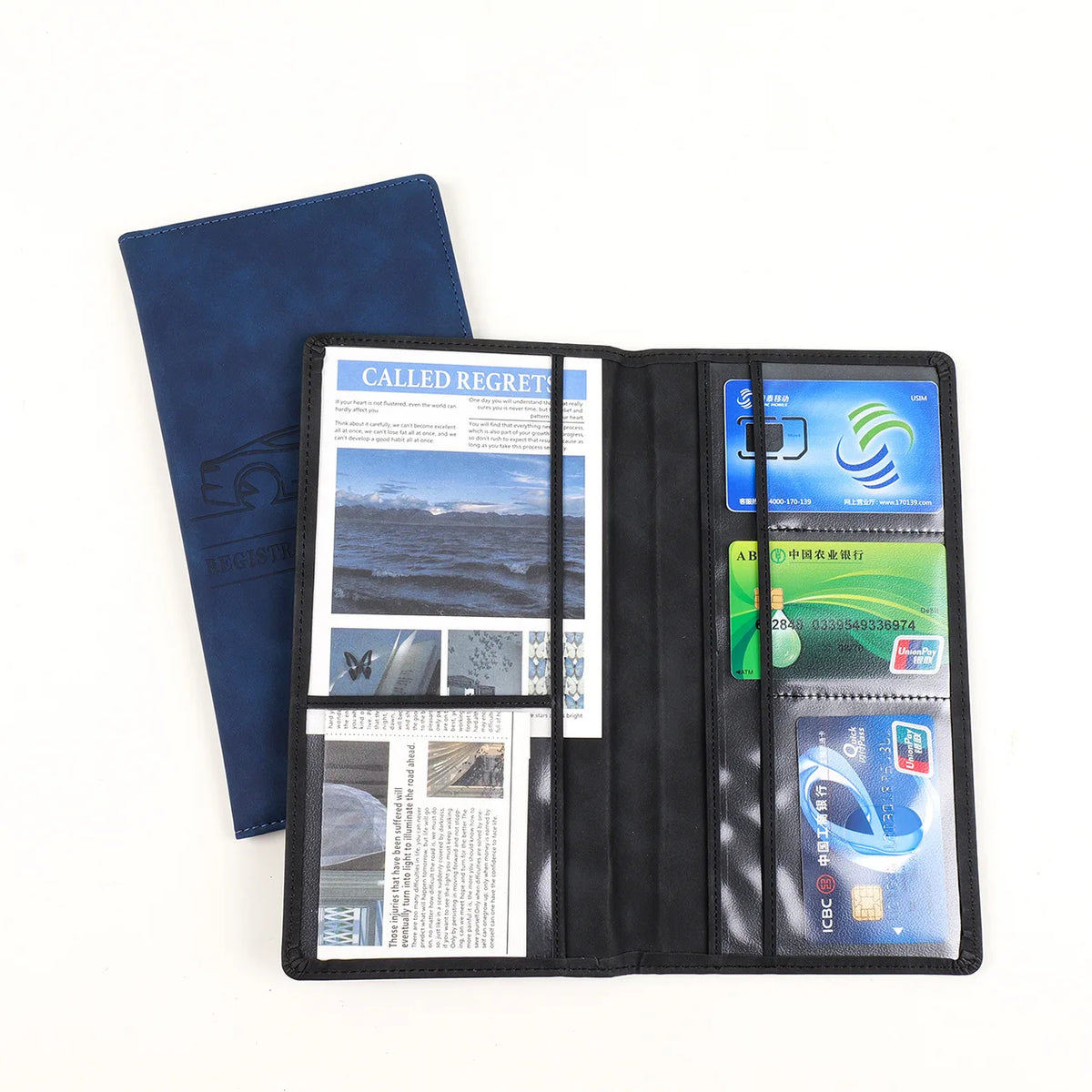 A black leather card holder wallet with a blue sleeve displaying various identification cards and documents.