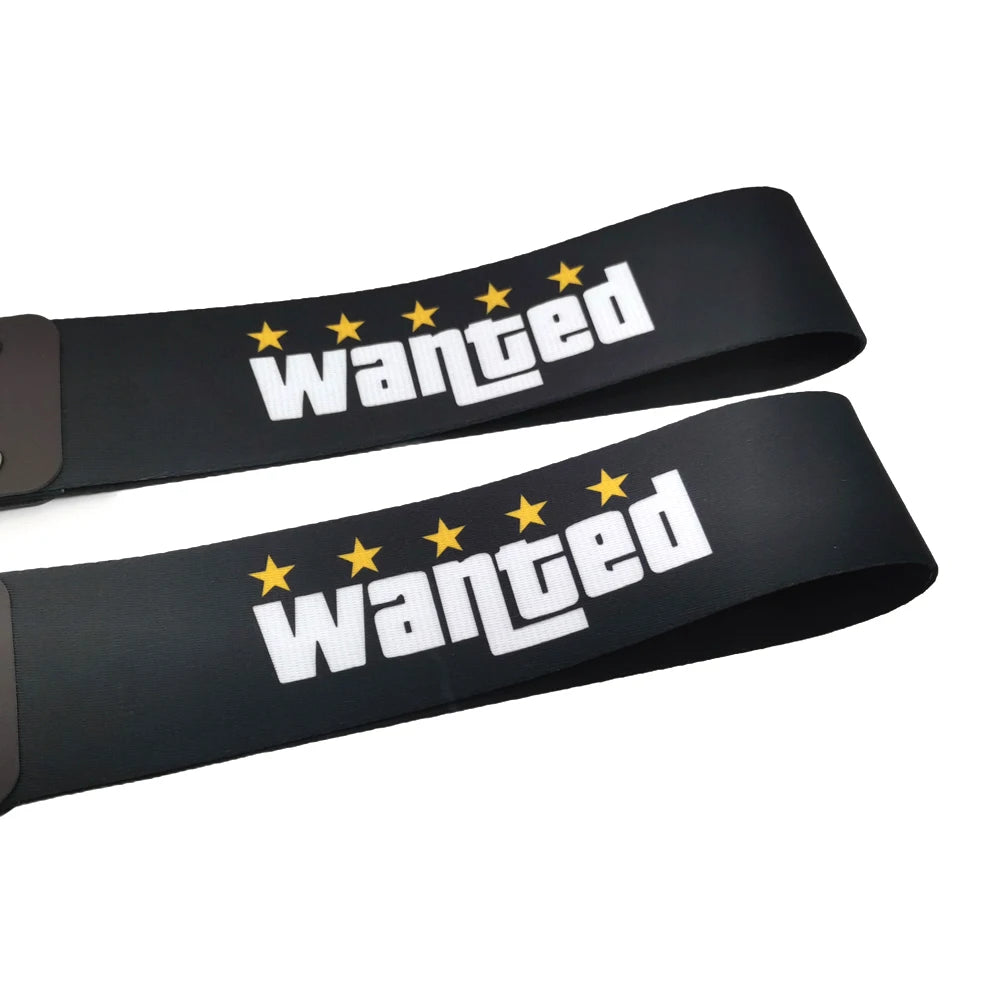 Black tow strap with white text reading Wanted and five yellow stars