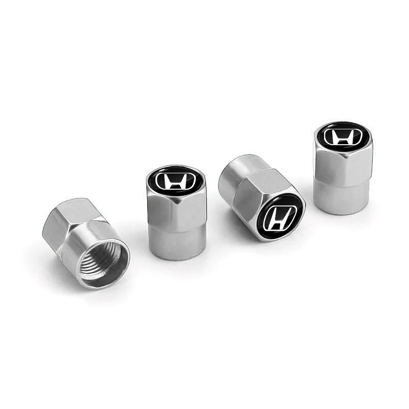 A set of four metallic tire valve caps with an H logo, shown against a white background.