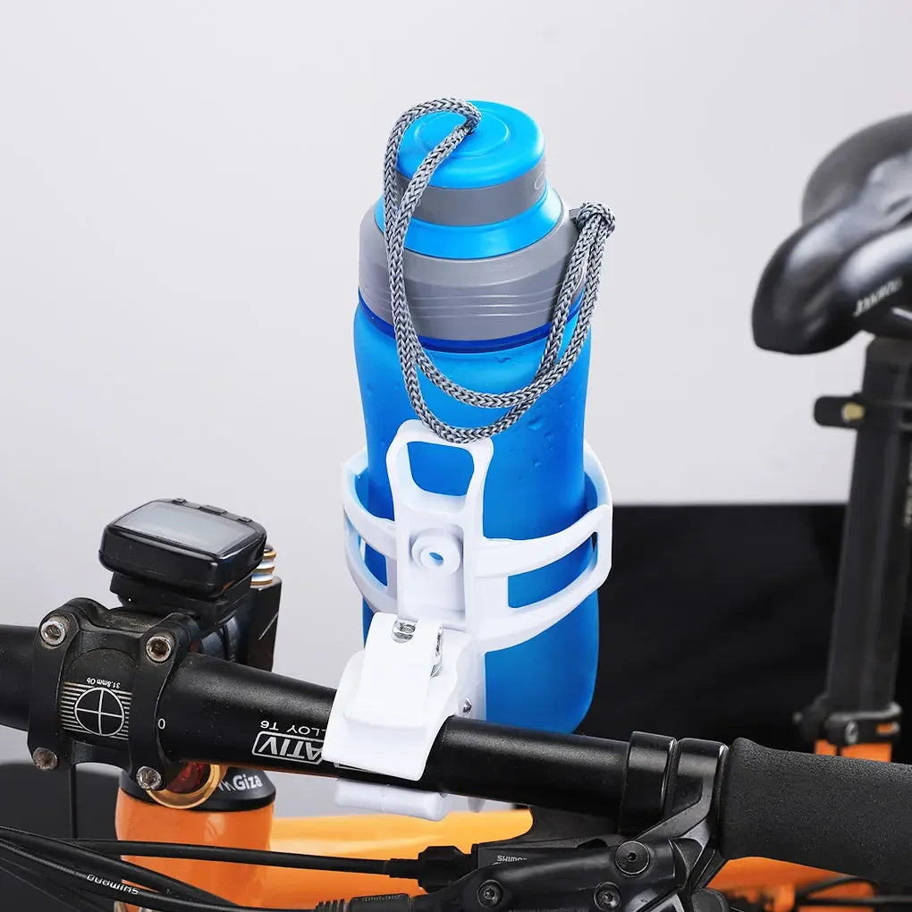 A blue water bottle cage with a silver strap is mounted on a bicycle handlebar.
