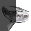 Close-up view of a clear automotive headlight assembly with a dark tint film applied.
