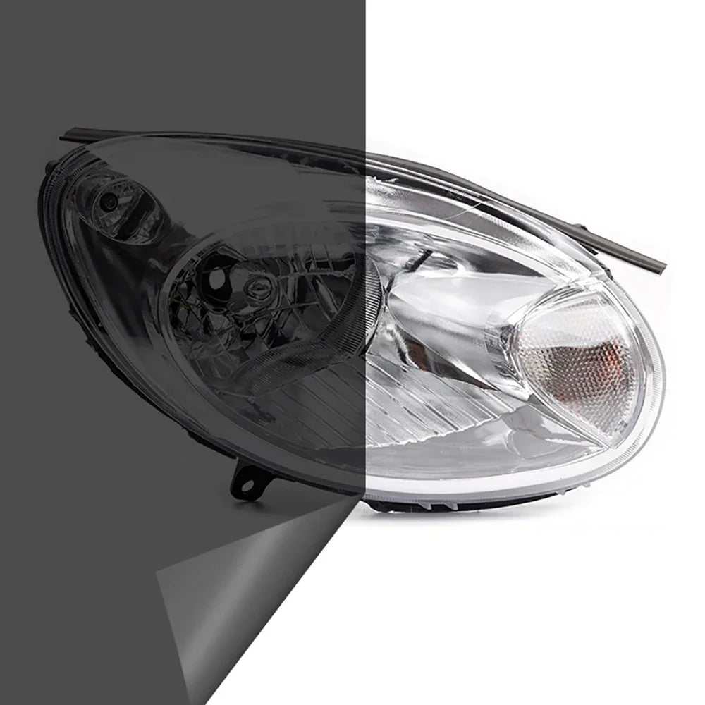 Close-up view of a clear automotive headlight assembly with a dark tint film applied.