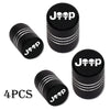 Four black Jeep tire valve caps with white lettering shown individually.