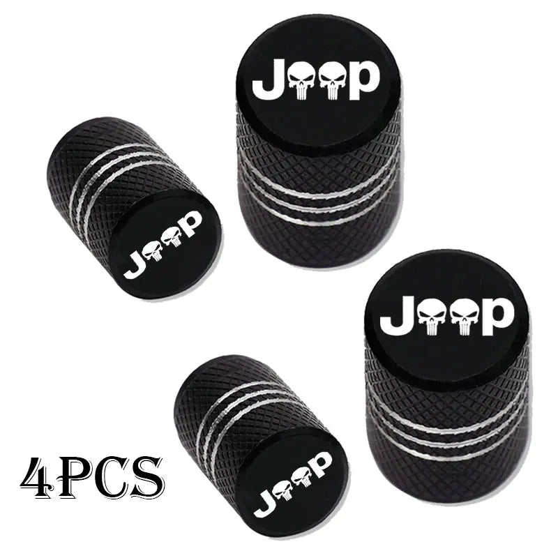 Four black Jeep tire valve caps with white lettering shown individually.