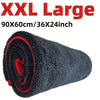 A rolled black microfiber drying towel with red accents shown against a white background.