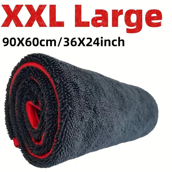 A rolled black microfiber drying towel with red accents shown against a white background.